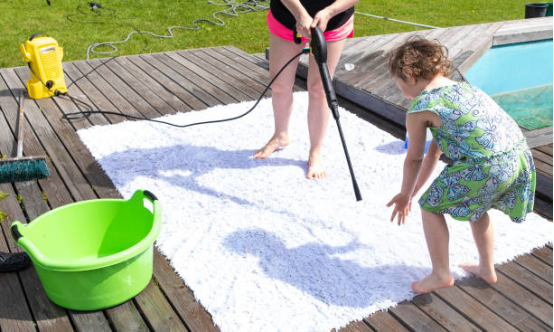 Electric pressure washer restoring shine to outdoor furniture
