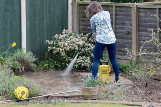 Close-up of nozzle spraying water on stone patio