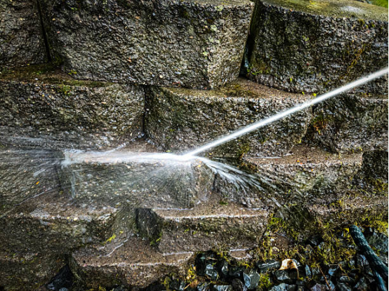 Before and after electric pressure washer cleaning stone