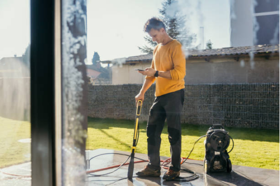 Electric pressure washer in use on a driveway, demonstrating frequent cleaning