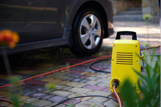 Close-up of electric pressure washer nozzle showing stable high-pressure output