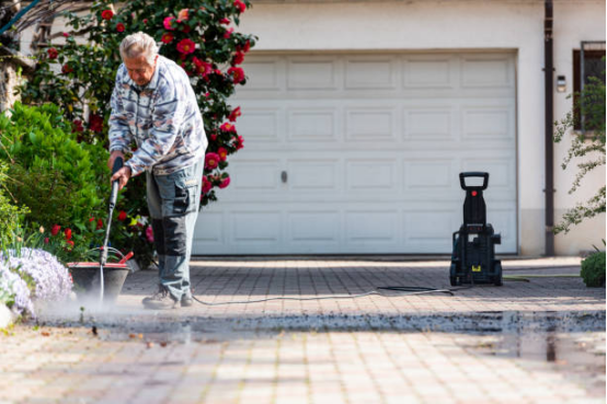 User performing routine maintenance on electric pressure washer for high-frequency use