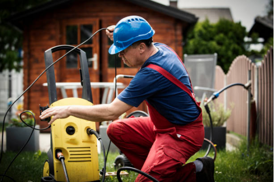 Electric pressure washer in use on a driveway, demonstrating frequent cleaning