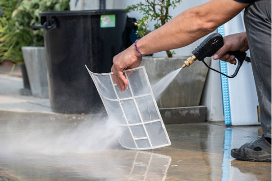 Electric pressure washer cleaning a patio efficiently