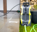 Modern yellow and black electric pressure washer ready for cleaning outdoor patio surfaces.