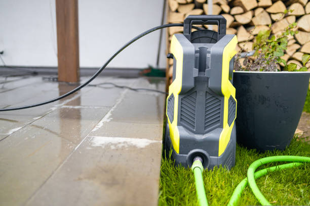 Modern yellow and black electric pressure washer ready for cleaning outdoor patio surfaces.