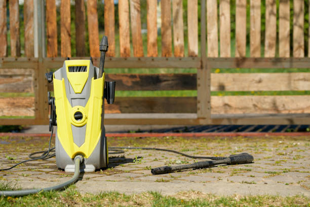 Yellow and grey electric pressure washer ready for cleaning outdoor patio or deck.