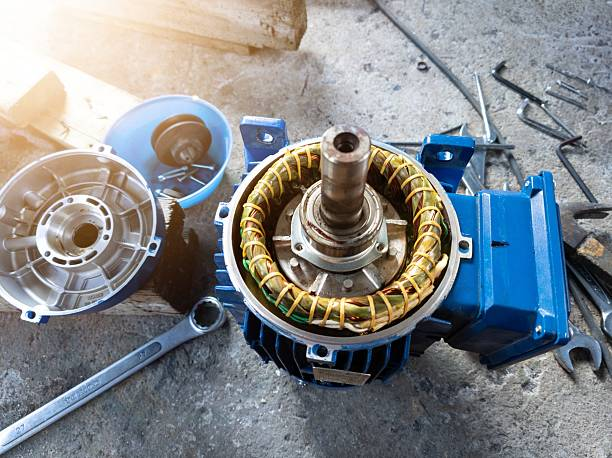 Disassembled blue electric motor with copper windings.